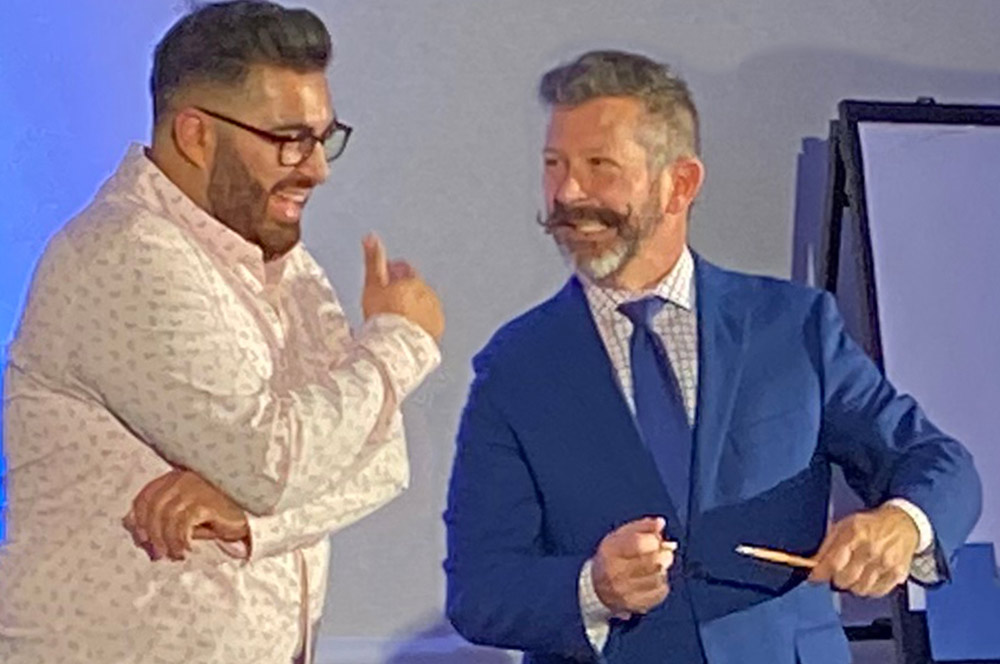 Mark Phillips magician on stage with audience member.